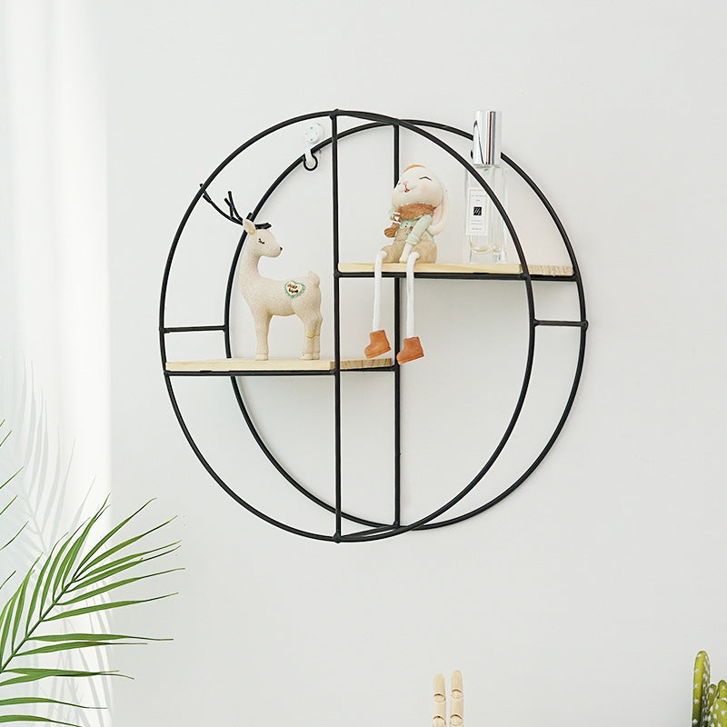 Black circle wall rack with minimalist decor
