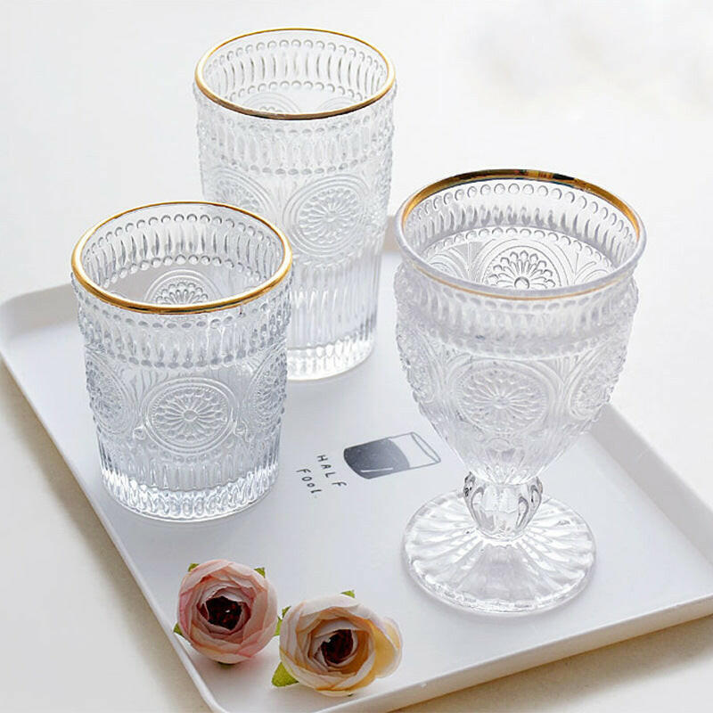 SHOND™ Gold-Rimmed Sunflower Glasses on a tray with flower
