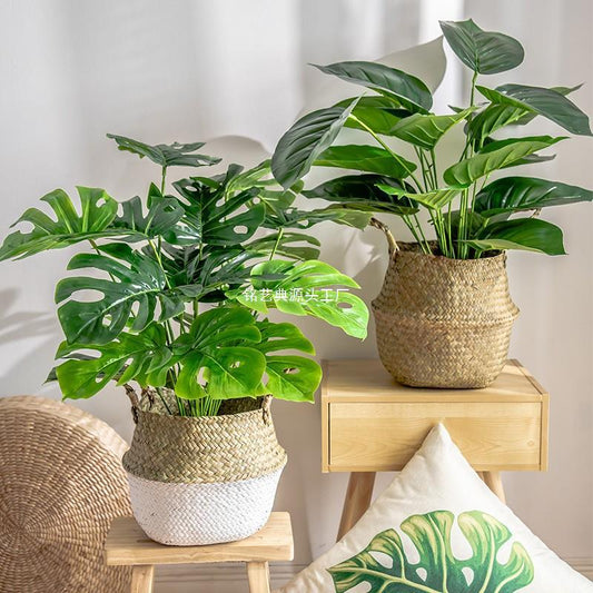 Faux plants styled on a modern wooden shelf
