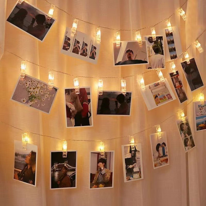 Warm white glow lighting up photos in bedroom setting
