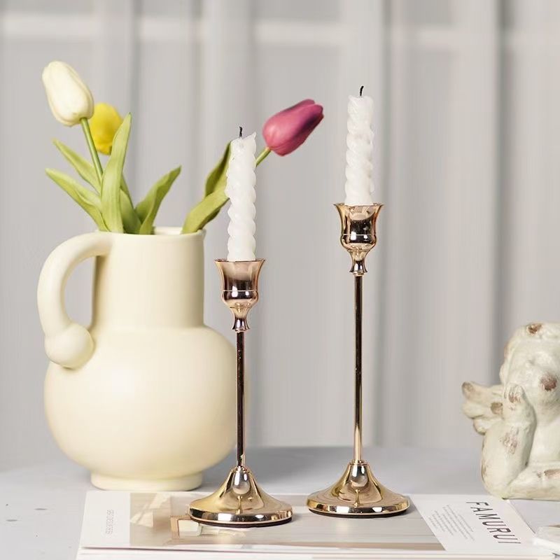 Candle holders on linen dining table with flowers
