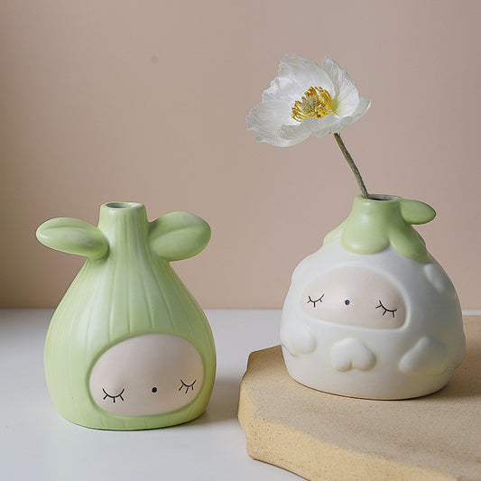 SHOND™ white and green seed vases on minimalist table

