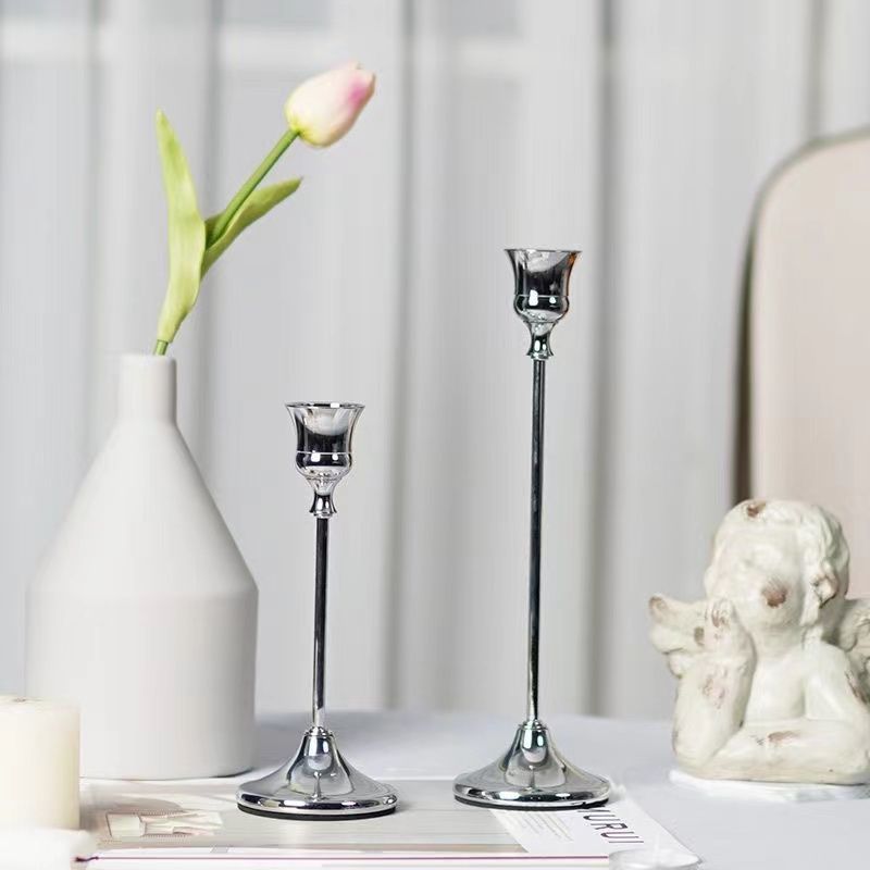 Trio of silver candle holders arranged elegantly
