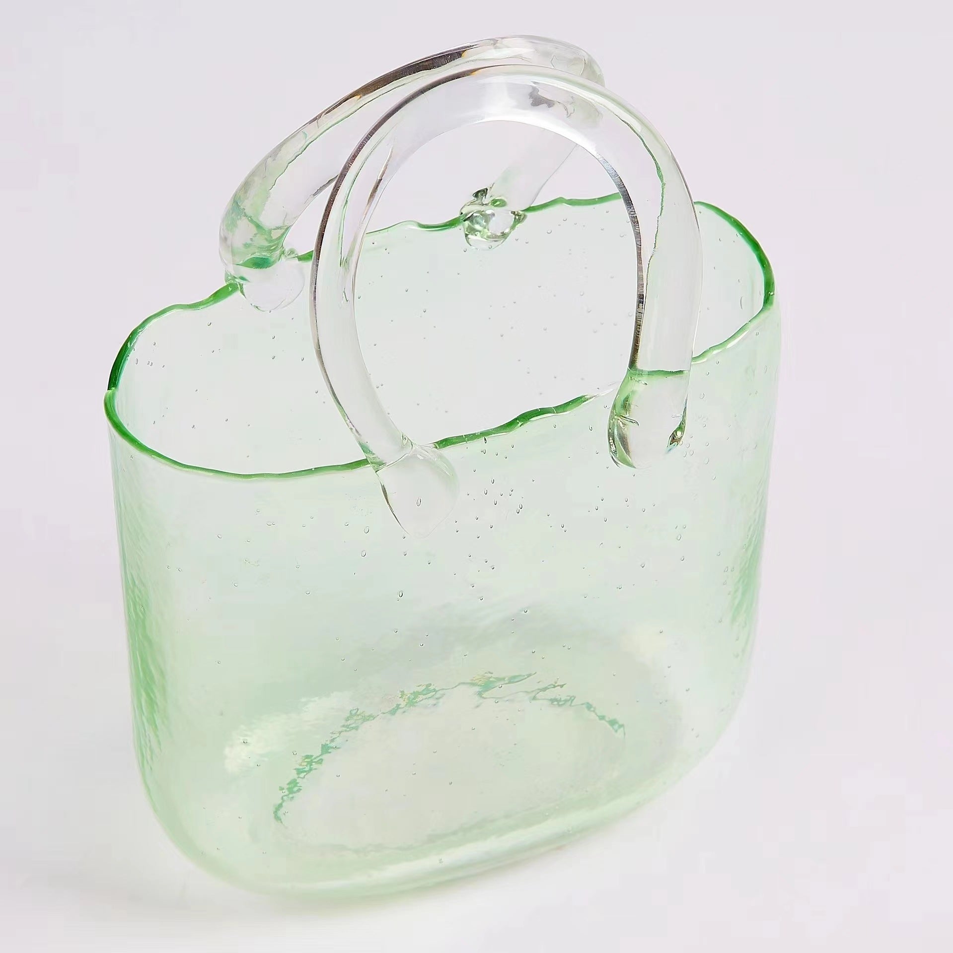 Green hydroponic vase with leafy cuttings
