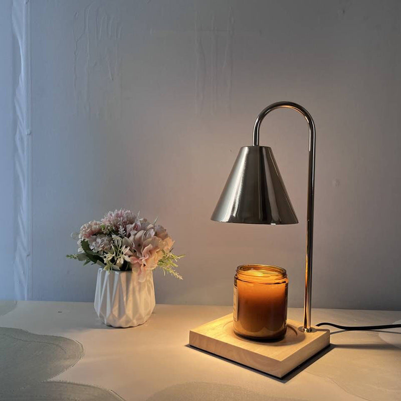Close-up of gold lampshade and wax melting tray
