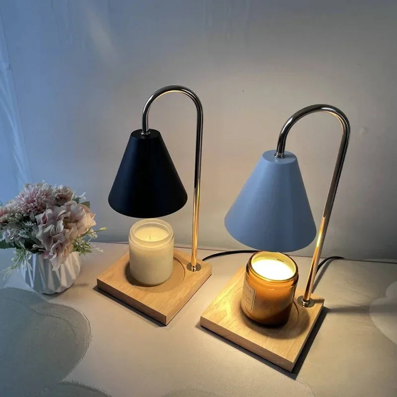 Lamp glowing softly beside books and ceramic vase
