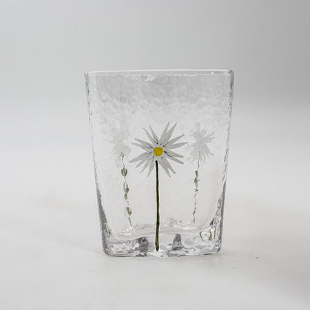 Glass cup with floral design and gold edge 
