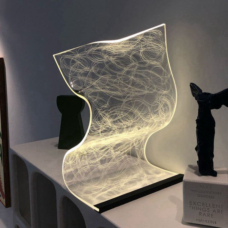 StreamGlow mood lamp with acrylic ripple design glowing on a nightstand
