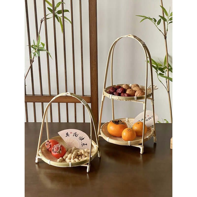 Bamboo tiered tray on dining table with candles and decor
