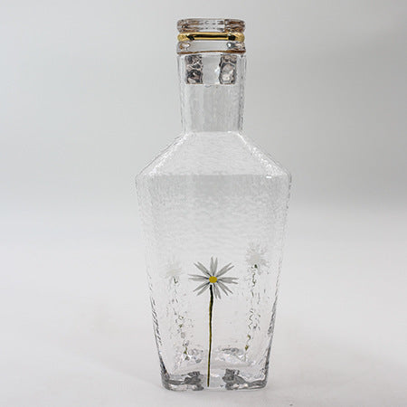 Glass jug with floral design and gold edge 
