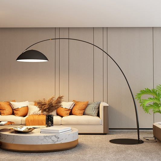 Nordic arc floor lamp with black marble base in minimalist living room
