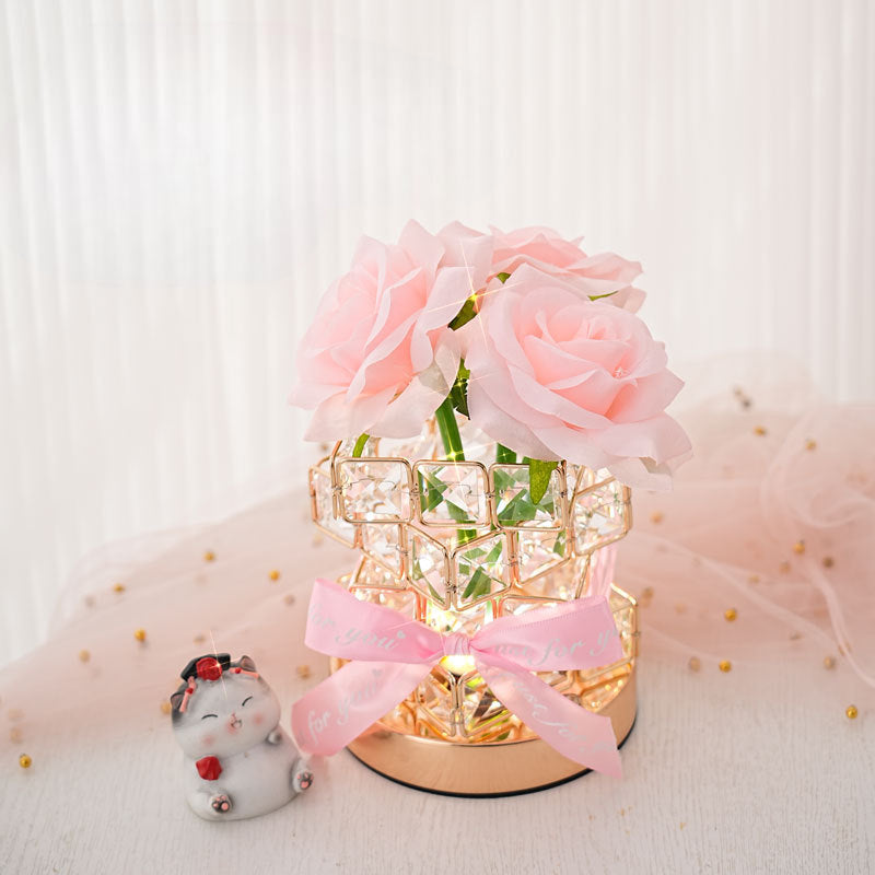 Romantic rose light on a bedside table next to a cat figure
