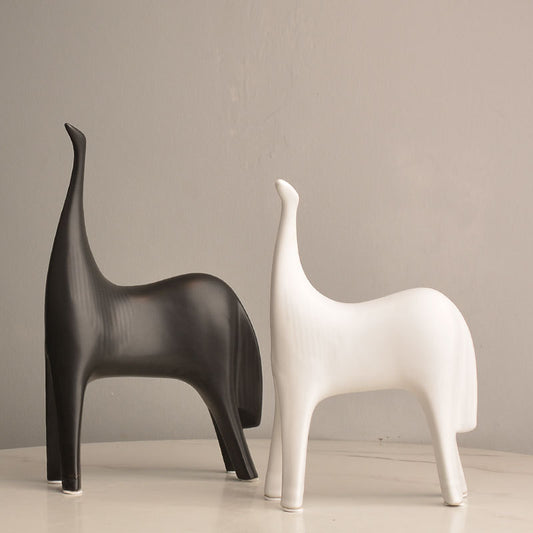 SHOND™ ceramic couple sculptures in black and white on a minimalist console
