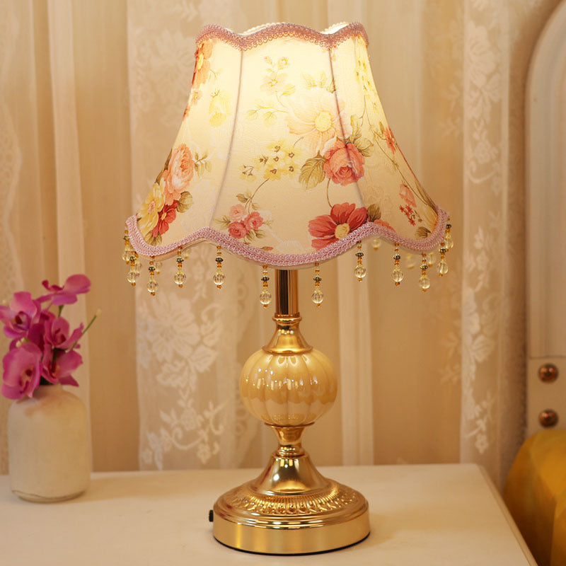 Mid-century styled table lamp on desk with warm light glow
