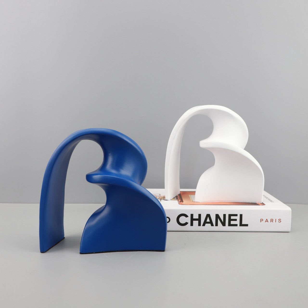White Nordic arch sculpture on modern console with neutral backdrop
