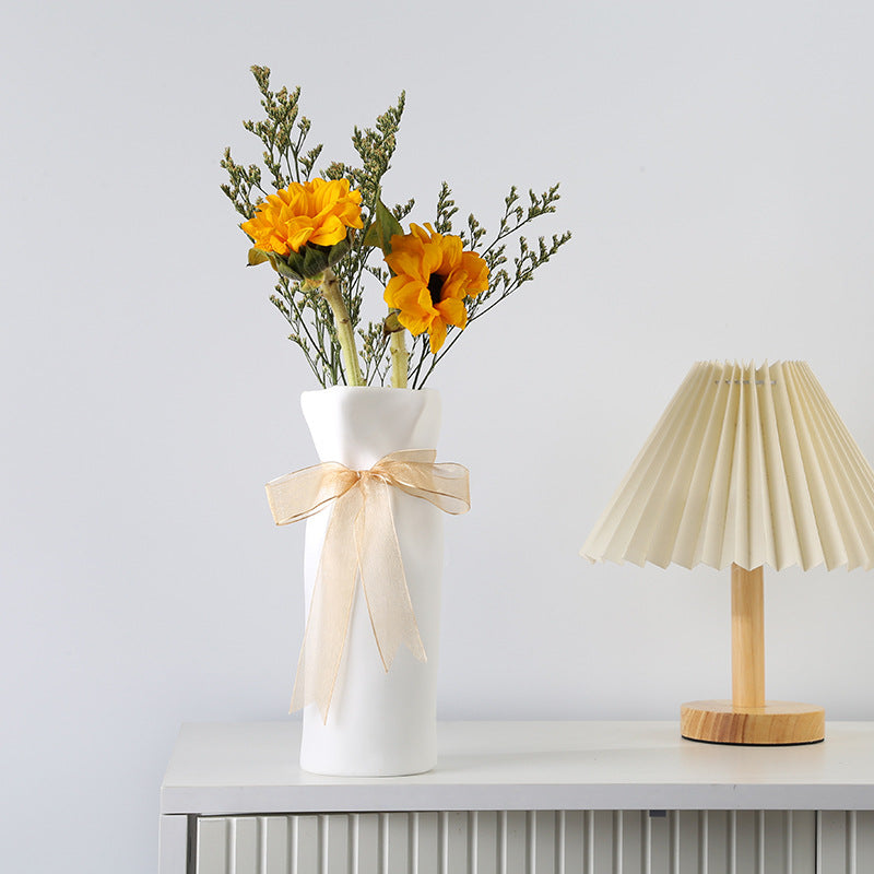 Wide-fold vase on shelf with minimalist decor
