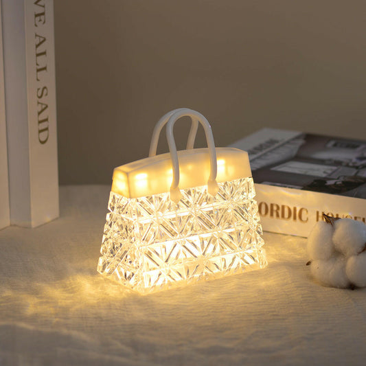 CrystalGlow™ handbag-shaped LED night light glowing in warm white
