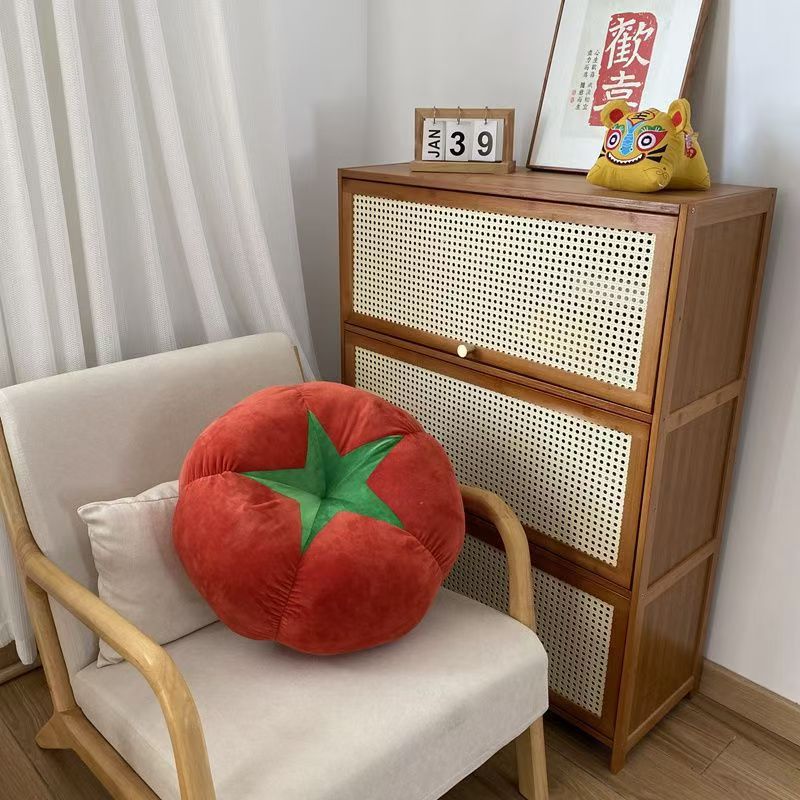 Tomato-shaped cushion showing plush texture and details
