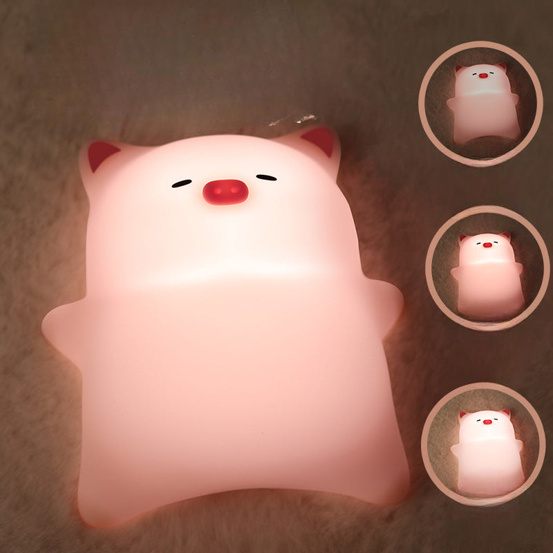 Glow Pal™ animal night lights glowing in warm white on a bedside table
