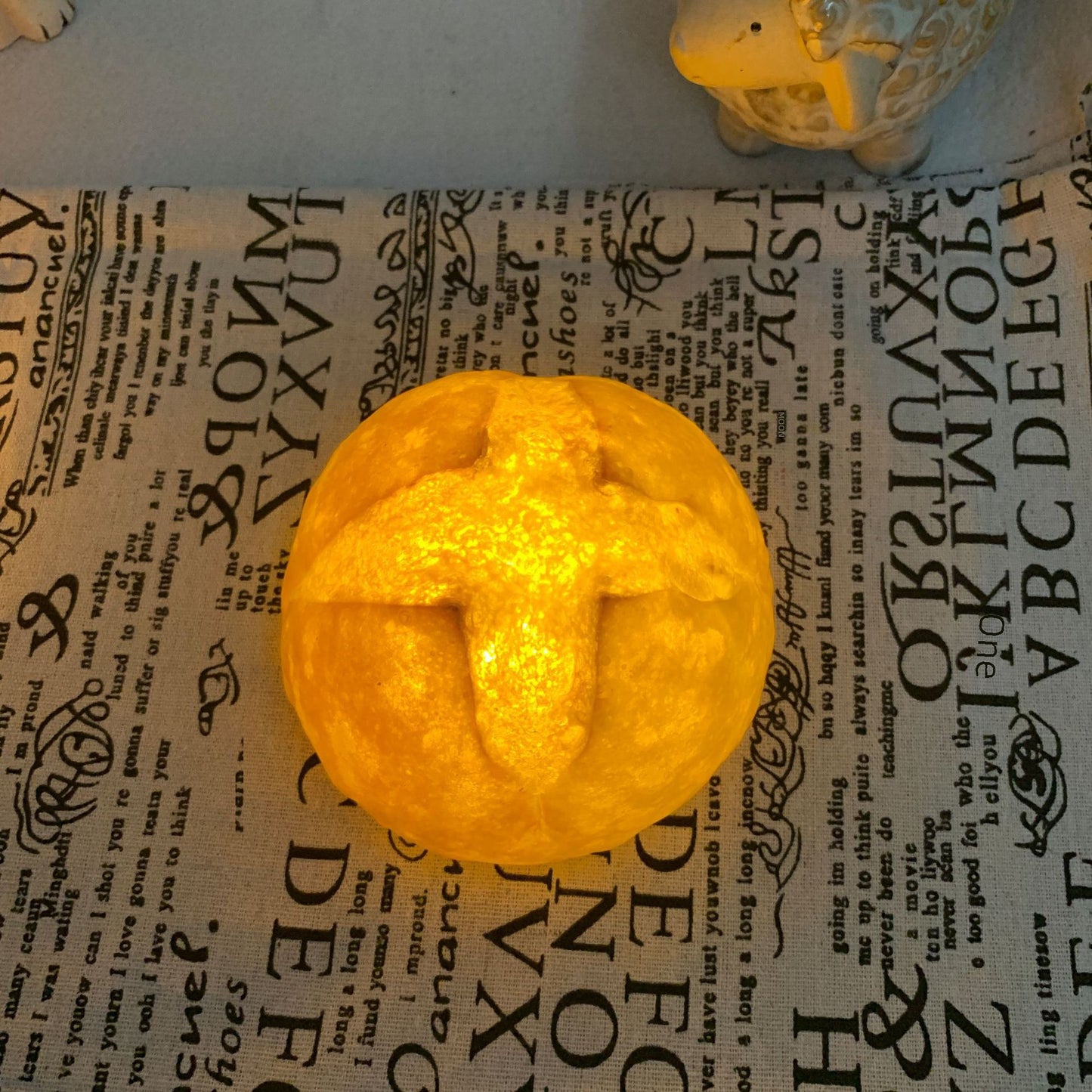 CroissantGlow™ LED bread night light in warm white on a bedside table
