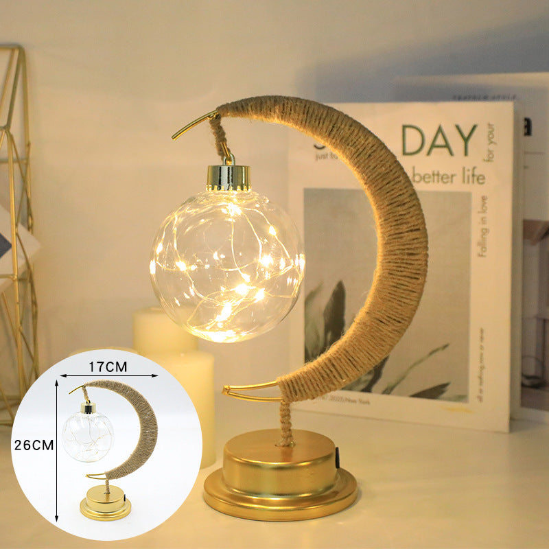 Hemp ball rope light glowing on wooden shelf
