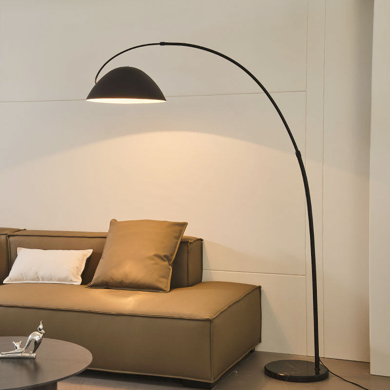 Modern Scandinavian room with arc lamp beside linen sofa

