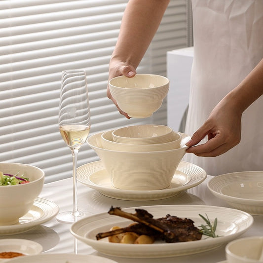 SHOND™ milky white ceramic plates and bowls on white table

