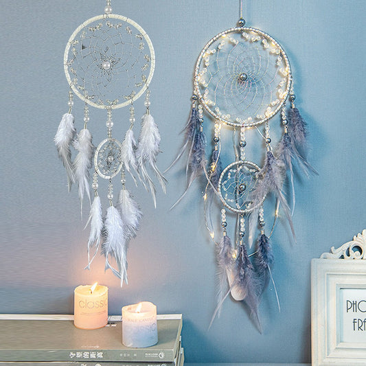 White LED dreamcatcher glowing softly on bedroom wall

