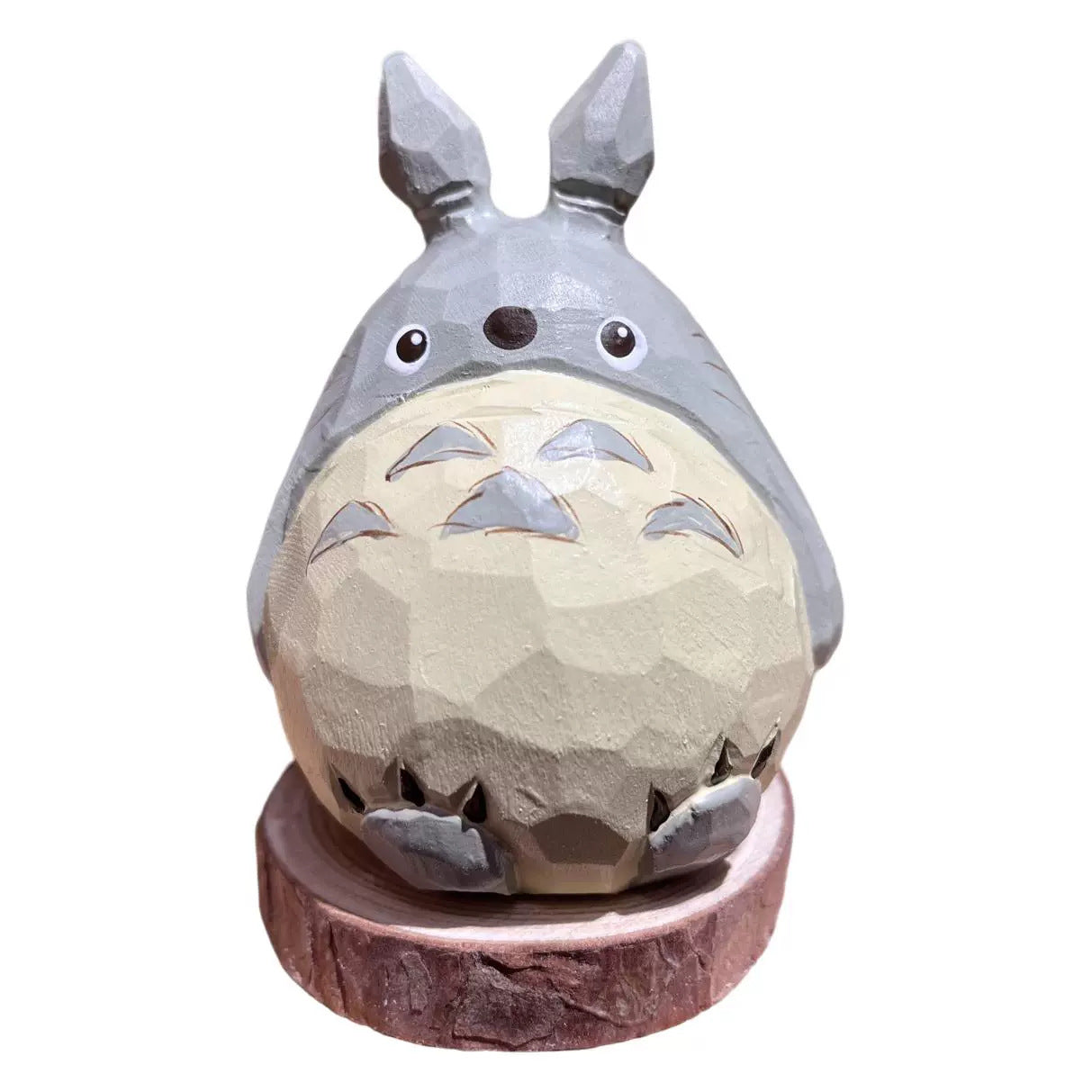 Rear and side profile of wooden cartoon chinchilla figurine
