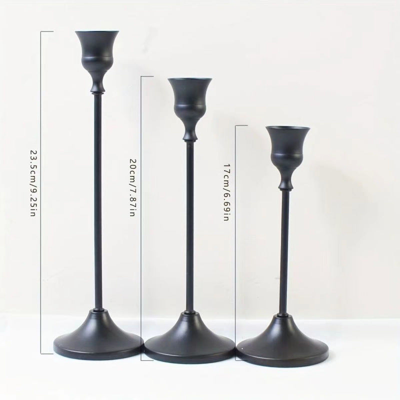 Metal bell-shaped candle holders in matte finishes
