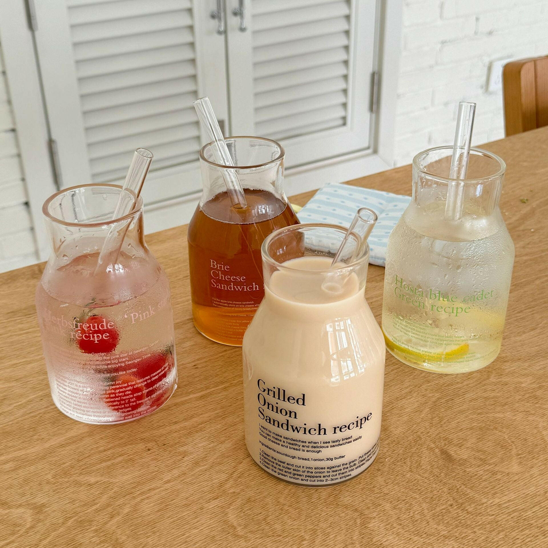 4 mugs arranged on clean, Scandinavian-style table
