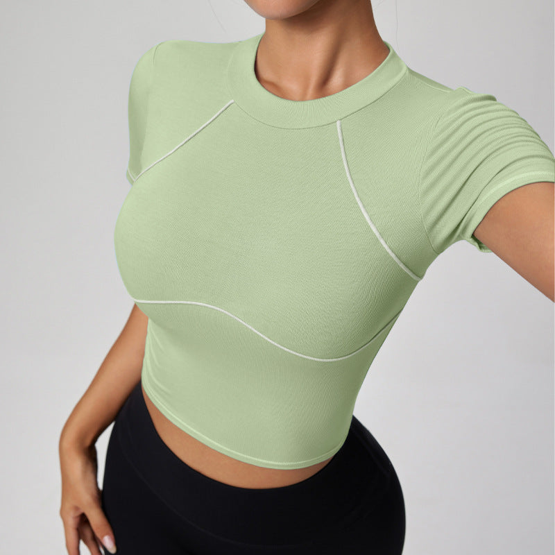 Light green athletic top worn by a person on a plain background