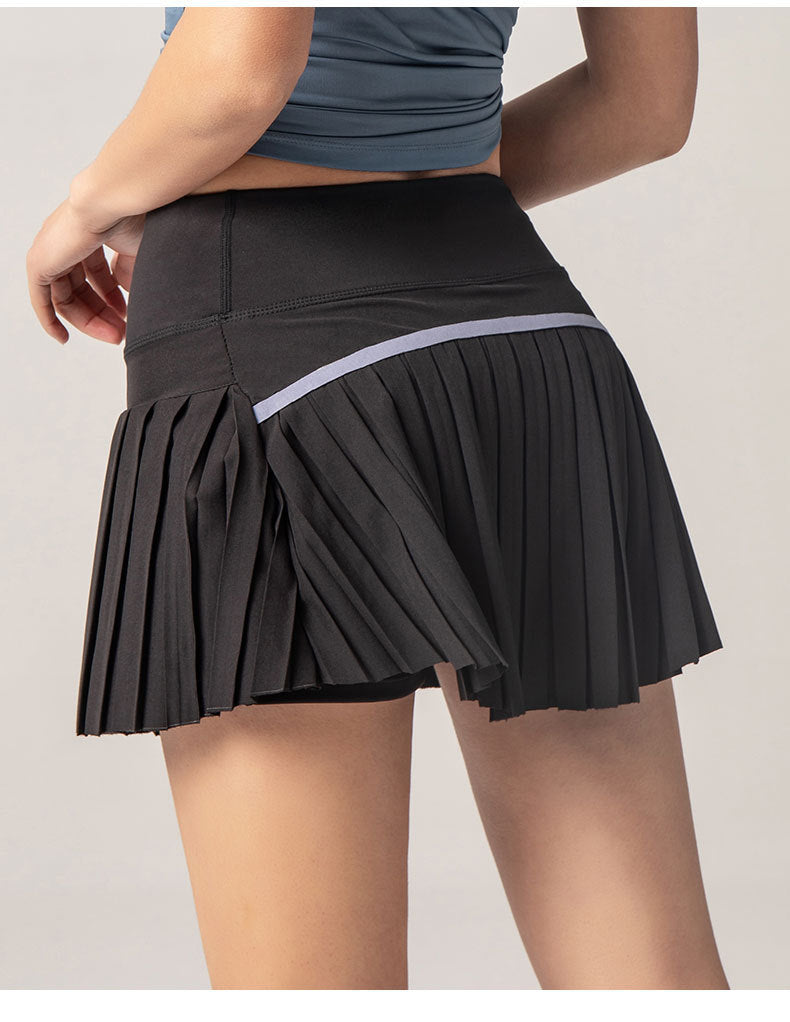 Black pleated skirt worn by a person on a light gray background