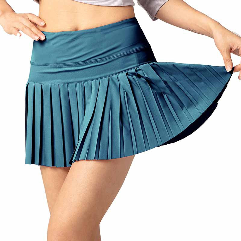 Teal pleated skirt worn by a person on a white background