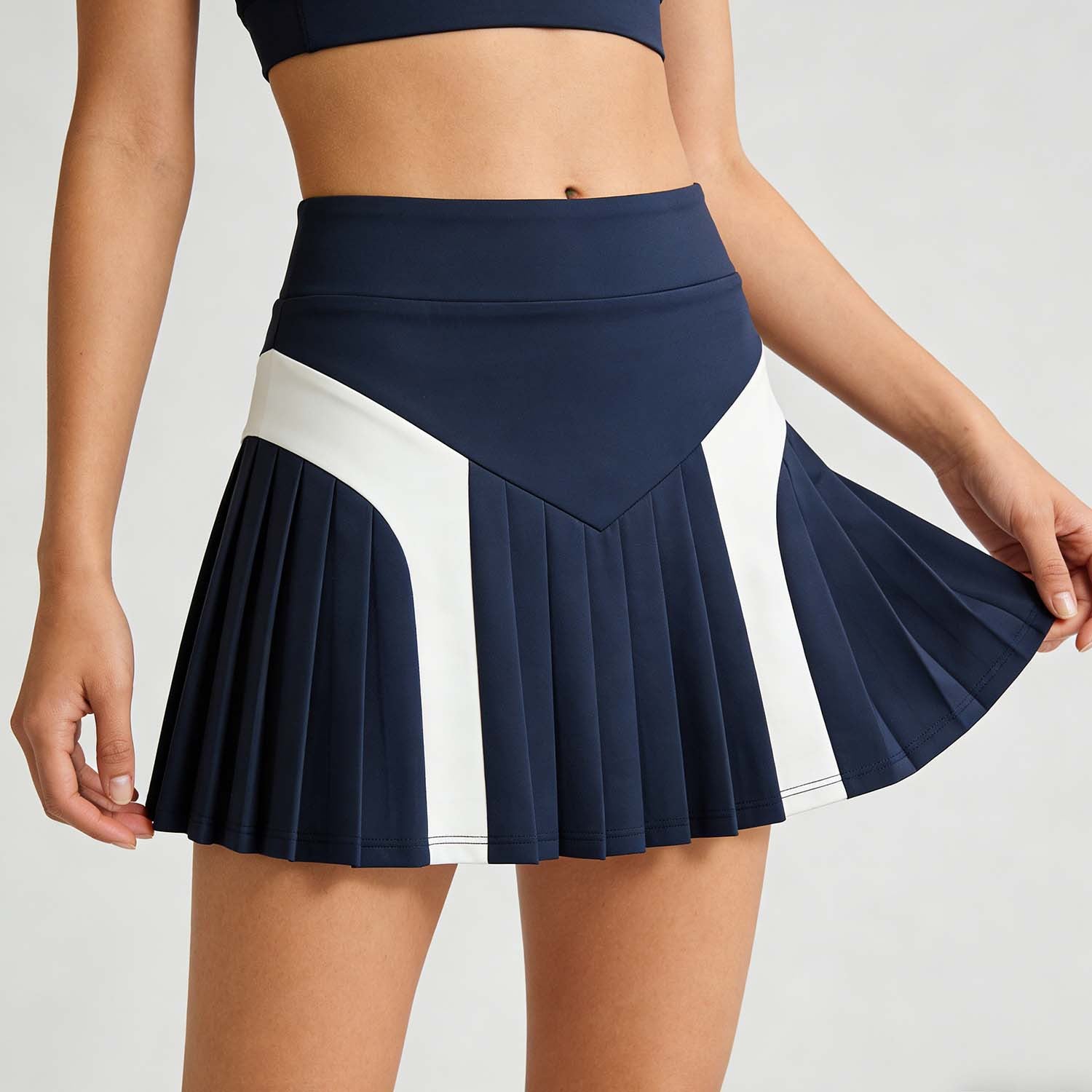Navy pleated skirt with white stripe on a plain background