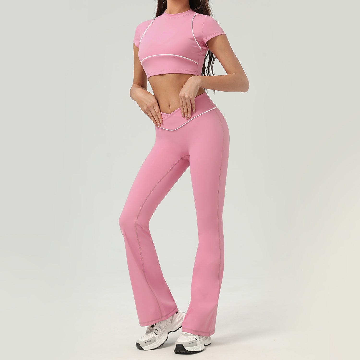 Person wearing a pink athletic outfit on a light gray background