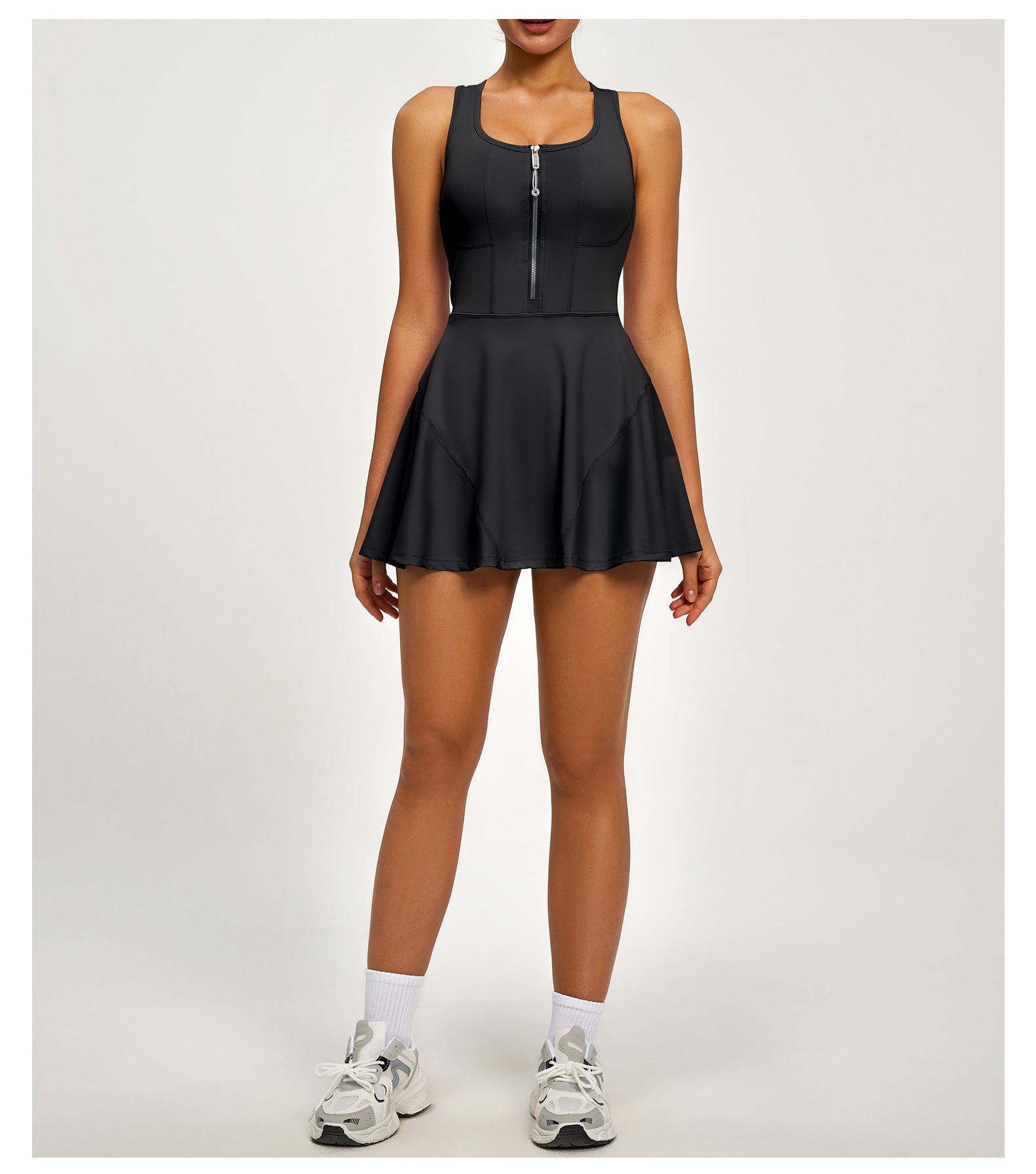 Black tennis dress worn by a person on a white background