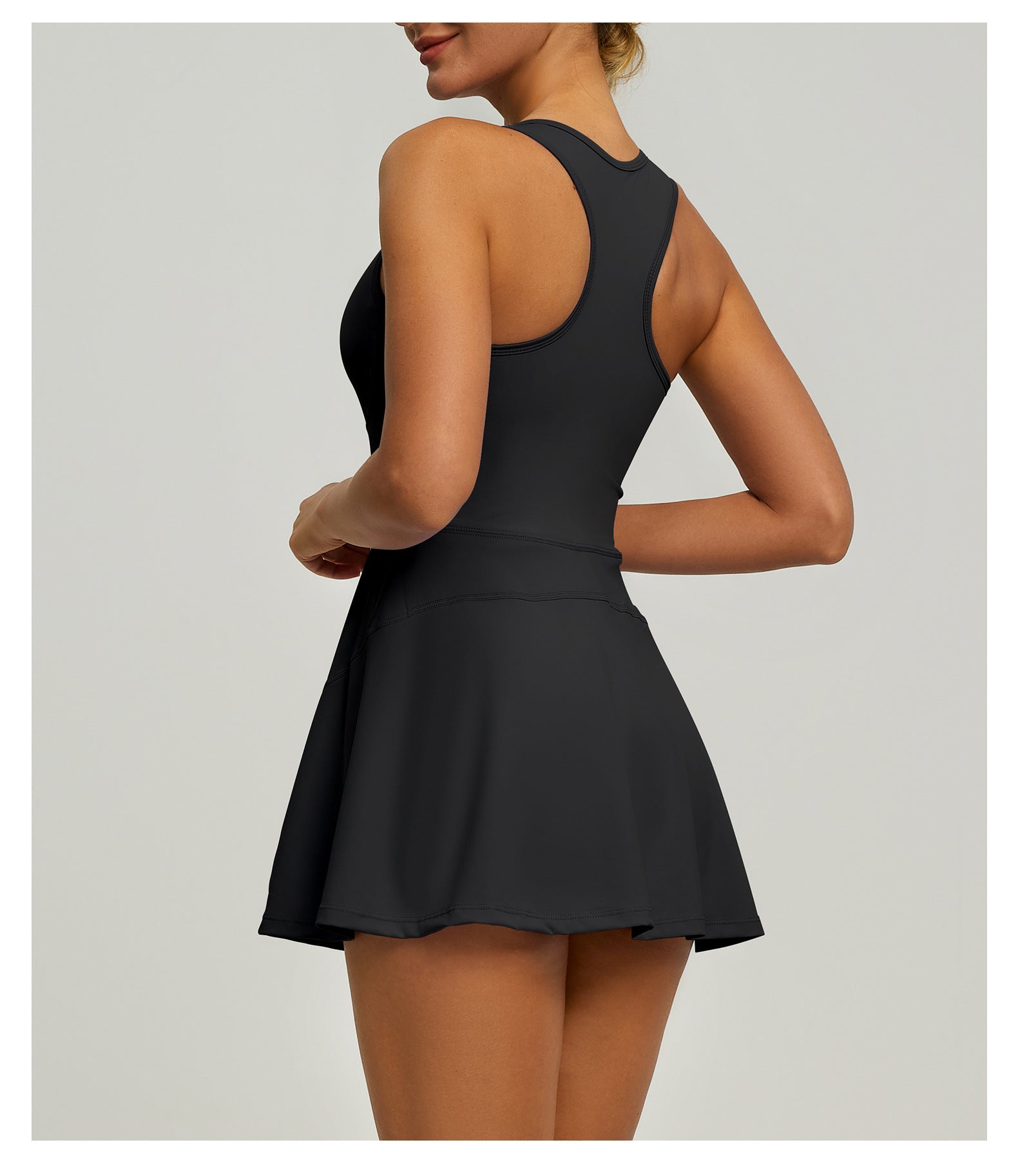 Black dress worn by a model on a plain background