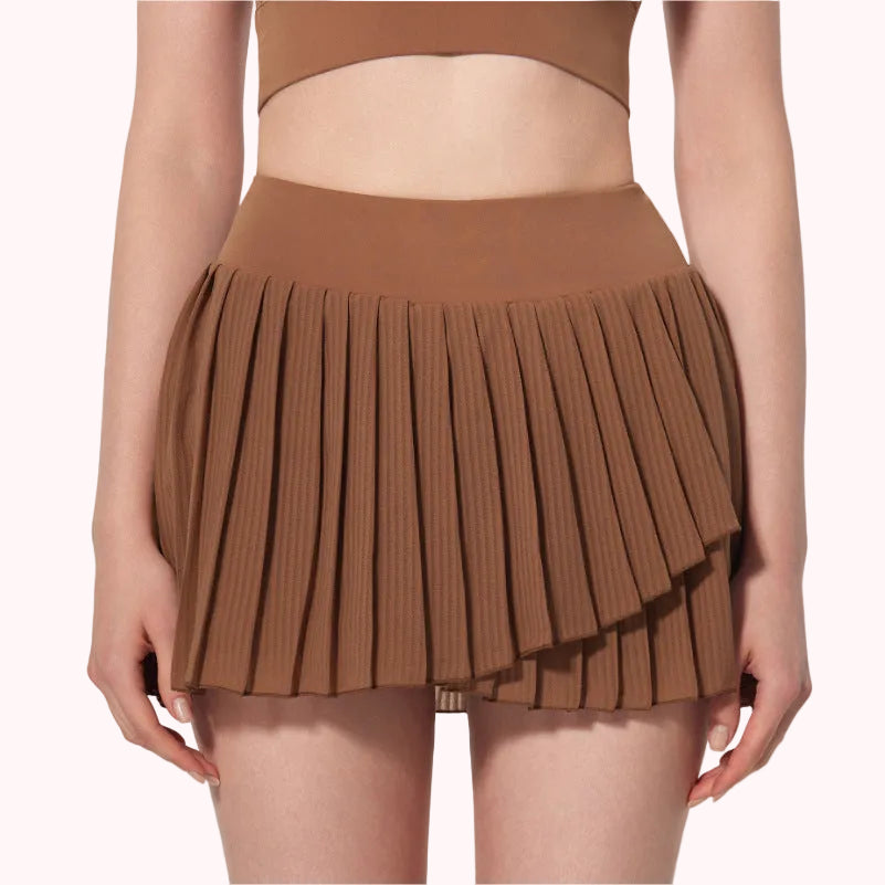 Brown pleated skirt worn by a person on a plain background