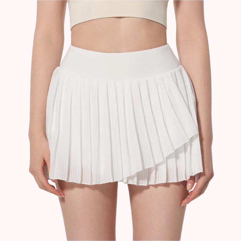 White pleated skirt worn by a person on a plain background