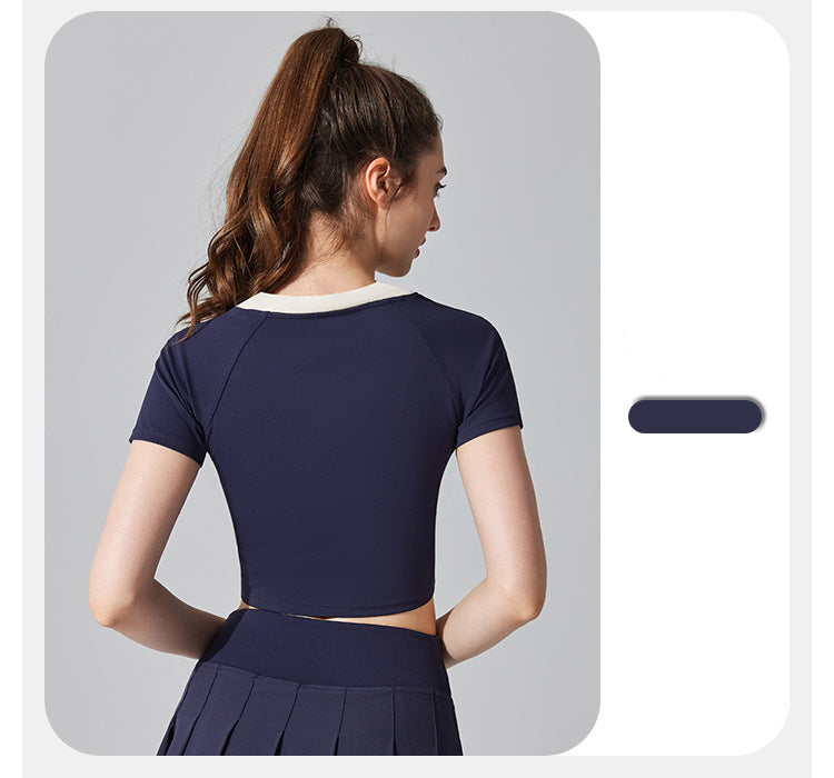 Woman wearing a navy blue outfit on a gray background
