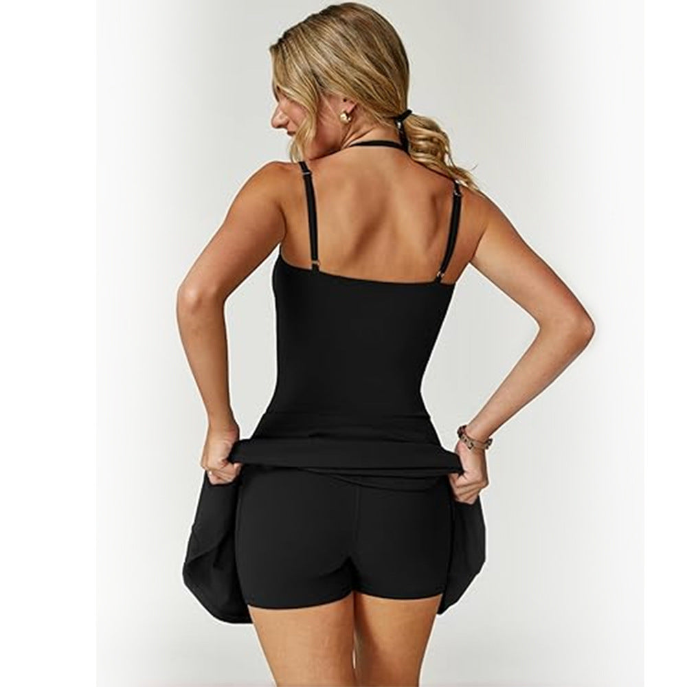 Woman wearing a black tank top and shorts on a white background