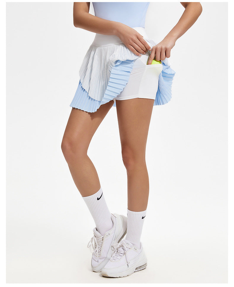 Person wearing a white and blue tennis outfit with Nike socks and shoes on a white background