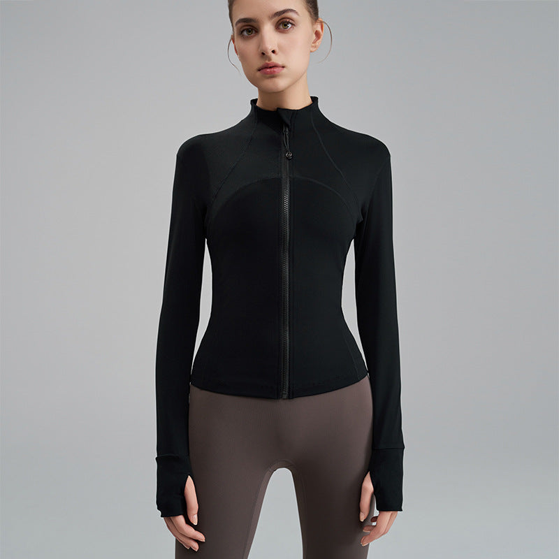 Person wearing a black long-sleeve athletic top on a gray background