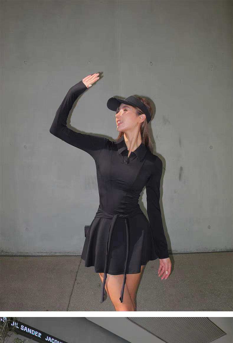 Woman wearing a black dress and visor against a gray background